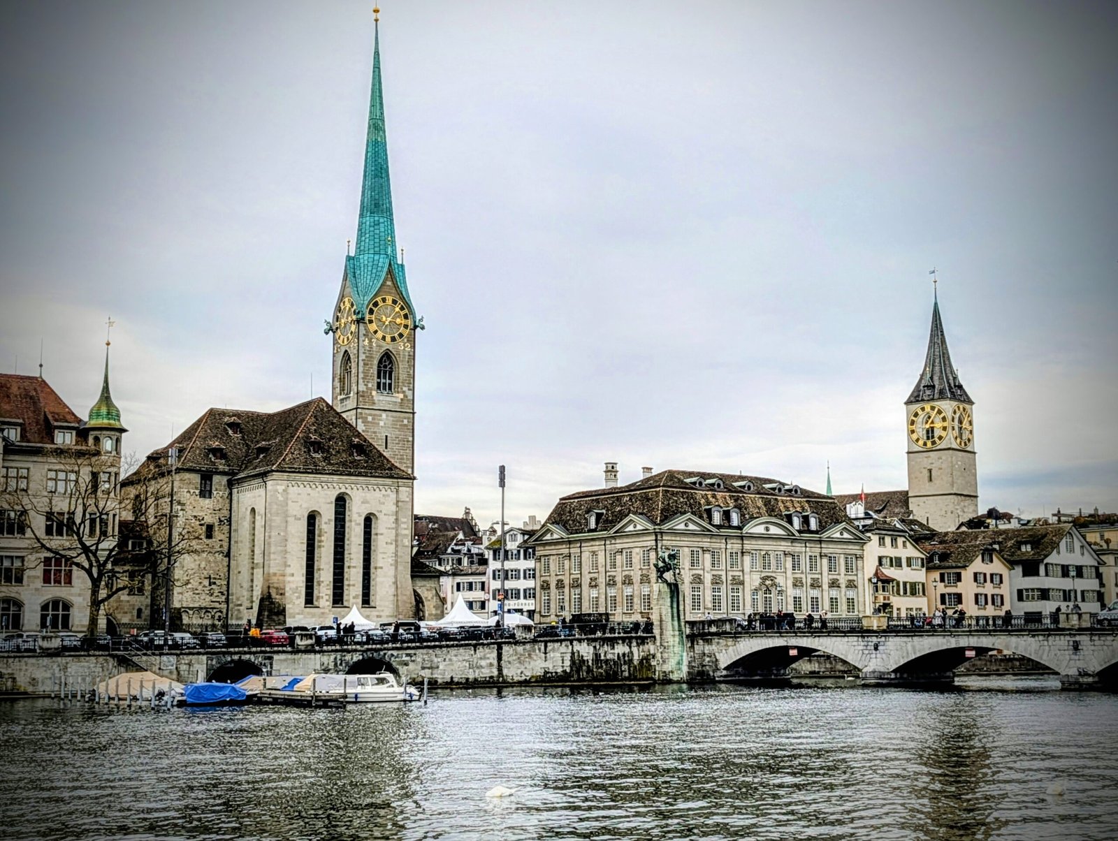 Historic buildings and church towers, including Fraumünster and St. Peter's Churches, along the Limmat River in Zurich, Switzerland, viewed from the waterfront.